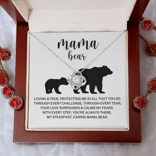 Necklace with 'Mama Bear' pendant and card on a decorative background