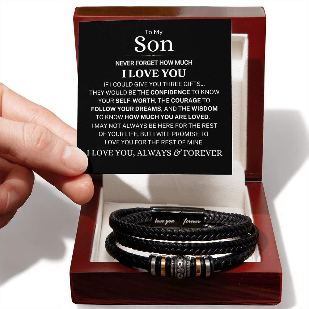 Stack of black leather bracelets in a wooden box with a sentimental message card.